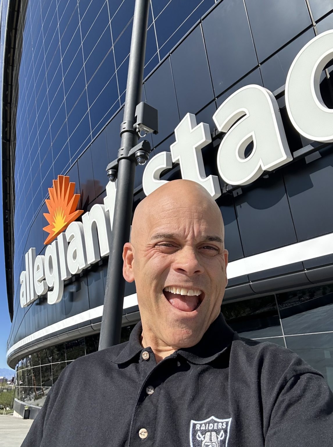 John smiling outside Allegiant Stadium